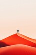 © Hryhor Denys - A lone figure stands gracefully on a striking red dune, surrounded by endless sand, embodying solitude and adventure in a tranquil desert environment