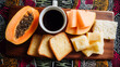 © Haki - Café da manhã brasileiro tradicional com pão francês, fatias de queijo, café preto quente, banana, mamão e jornal sobre mesa rústica de madeira. Vista superior sem pessoas