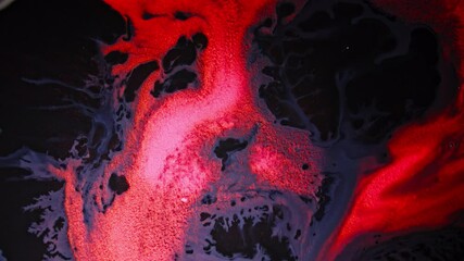 Wall Mural - red liquid and black ink swirling in close-up, abstract and dramatic macro shot