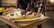 © peopleimages.com - Measure, teamwork and construction with hands of people for design production, furniture and manufacturing. Collaboration, handyman and framework with craftsman for building project and woodworking