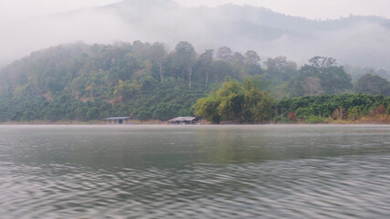 the river and mountain views on foggy morning