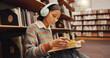 © peopleimages.com - Woman, student and headphones at library with reading book on floor, study and song with scholarship at college. Girl, education and listening to music, streaming and prepare for test at university