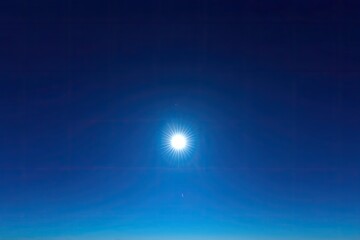 bright sun in a dark blue sky