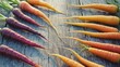 © Oleg - The carrots are vividly colored with orange, yellow, purple and red hues. They appear fresh and ripe, suggesting they were recently harvested from a garden or farm.