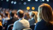 © Kenny - Audience of adults at business conference with focus on female speaker