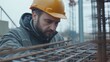© LorelEino - Project manager inspecting reinforced concrete framework. Featuring oversight and quality control