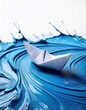 © Simon - Origami paper boat on swirling blue paint waves