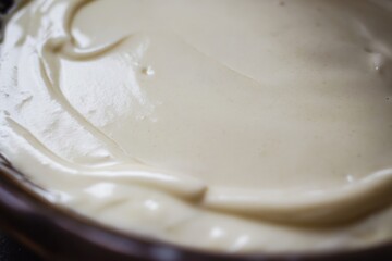 Poster - Creamy Delight: A smooth, luscious, ivory-colored dessert filling spreads across a dark dish. Tempting and simply scrumptious.
