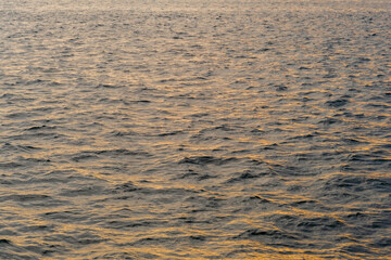 Poster - Waves of the Bosphorus reflecting the golden hues of sunset over tranquil waters