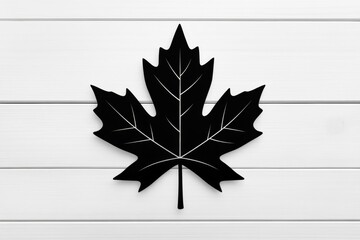 Wall Mural - A simple black silhouette of a maple leaf, placed against a white background