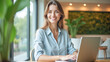 © Radorog. - happy female manager with laptop in office