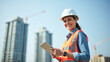 © Radorog. - a female foreman in a white helmet with a tablet in her hands at a construction site