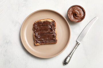 Wall Mural - plate of toast with sweet chocolate spread on white background