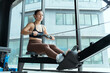 © 2B - Rowing workout session in a modern gym with large windows showcasing natural light
