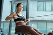 © 2B - Rowing workout session in a modern gym with large windows showcasing natural light