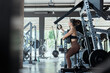 © 2B - Woman performing strength training in a modern gym during early morning hours for fitness routine and personal health goals