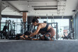 © 2B - Woman exercises with weights in gym while dog relaxes nearby during morning workout session