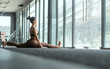 © 2B - Yoga practitioner demonstrates side plank pose in a modern fitness studio during daylight hours