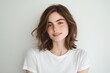 © ngalong project - Young woman with short brown hair wearing a white t-shirt smiles.