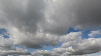 Wall Mural - Incredibly beautiful grey cumulus textured clouds under blue sky on partly cloudy day. Timelapse mode.