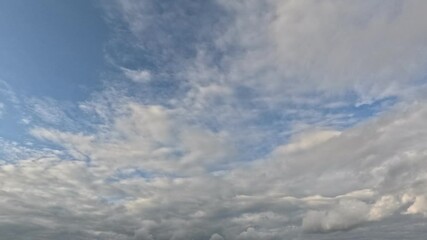 Wall Mural - Incredibly beautiful grey cumulus textured clouds under blue sky on partly cloudy day. Timelapse mode.