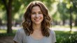 © Atallal Annas - Smiling Woman in Grey Shirt Standing Outdoors in a Park with Trees