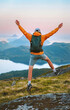 © EVERST - Man traveler happy jumping in mountains travel summer active vacations outdoor, tourist hiking healthy lifestyle freedom success concept mental health wellness eco tourism backpacking in Norway
