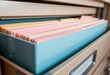 © Chatchawan - Pastel Colored Files Organized in a Light Blue File Box Inside a Filing Cabinet Drawer