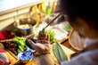 © Marko Geber - Chef carving wasabi leaf decoration in sushi restaurant kitchen