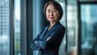 © Daiki - A confident middle-aged Japanese woman in professional attire stands poised in an office environment, exuding elegance and self-assurance.