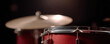 © Mind - Shiny red drum kit lit by single warm spotlight