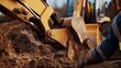 © Jorda - Construction worker operating a backhoe on a construction site. Featuring precision and machinery control