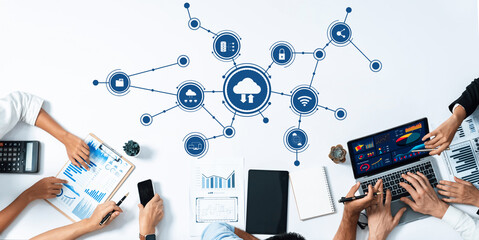 Fototapete - A top-down view of a collaborative workspace showcasing various digital tools and cloud connectivity while team members engage in data analysis and information sharing. Amity