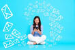 © New Africa - Email message. Happy woman using smartphone on light blue background. Envelopes flying out of device