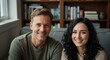 © Matt - Man and woman smiling together on a sofa in a cozy living room with a bookshelf