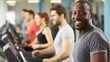 © Andres Mejia - Happy black man smiling while training on treadmill in gym