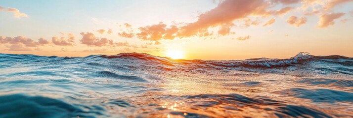 Leinwandbilder - Ocean waves at sunset with golden light illuminating the water and sky. The image captures a serene beach atmosphere with soft clouds and a vibrant horizon