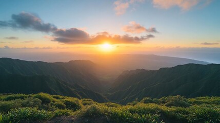 Aufkleber - A vibrant sunset casts warm hues over a mountainous landscape illuminating a lush green valley and distant coastal areas a scenic natural panorama