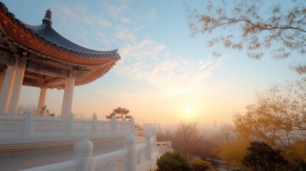 Aufkleber - A serene sunset view features a traditional white building with intricate roof details. The sky is painted with hues of blue and orange, with the sun setting over a city skyline and trees in autumn