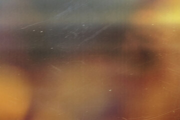 Wall Mural - grainy colorful warm orange light leaks on black background with dust texture. abstract damaged scra