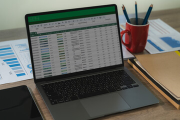 A professional analyst uses digital software and spreadsheets to present finance data, charts, and reports in a modern workplace.