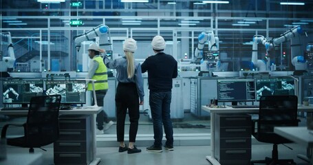 Poster - Diverse Factory Employees Using Laptop and Having a Conversation on a Production Floor. Robotic Arms Automate Electronics Assembly Inside a Facility. Automatic Conveyor is Powered by an AI Software
