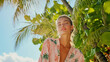 © Ruzana - Tropical summer fashion concept with model in beach attire under palm trees