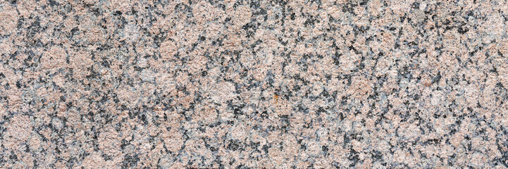 Wall Mural - Granite texture. Natural pink granite with a grainy pattern. Stone background. Solid rough surface of rock. Durable construction and decoration material. Close-up.