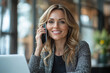 © Pixel Stream - Happy smiling mature middle aged business woman, 40s professional lady executive manager talking on the phone making business call on cellphone at work in office using laptop