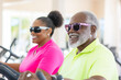 © Vilma - An older couple wears glasses while exercising at the gym, expressing joy, smiles, and contentment