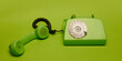 © master1305 - Classic green rotary phone in bold minimal composition on matching green background. Concept of retro aesthetics, vintage technology. Ideal for retro-themed banner, decor print, design, posters