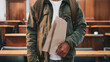 © Adam - Distressed immigrant holding folded legal document with anxious expression, immigration law and citizenship process concept, legal rights and human rights theme.