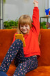© Andrii Iemelianenko - Happy child girl use mobile smartphone typing playing browsing found out great big surprise, good positive news, celebrate online game win. Teenager kid at home in living room sits on sofa. Vertical