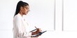 © Rawpixel.com - African American woman writing on a tablet in the office. African American business woman workingin with tablet in the white minimal office, African American woman writing, businesswoman in the office
